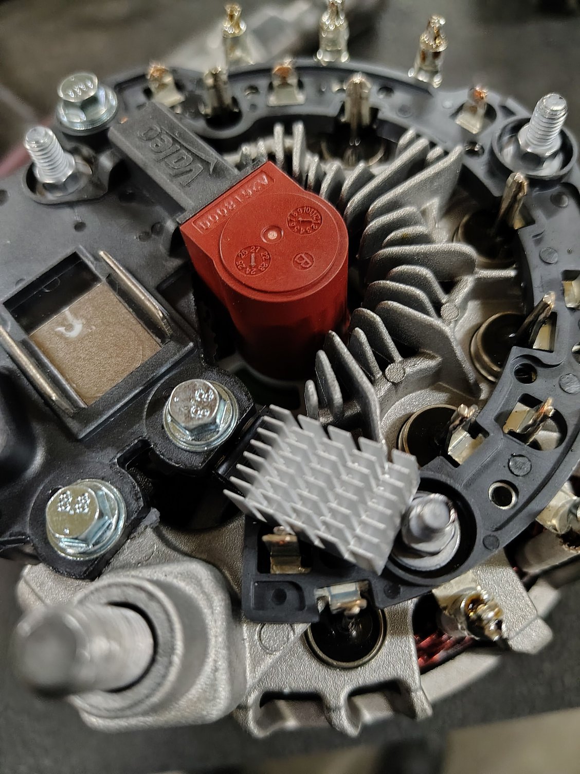 This is what the back of the alternator looked like when I took the new one off the car an popped the plastic back cover off.that heat grid is laying on the stud an against the wired post it's not post to be there .I put the old one back on same problem they sent me a new one I haven't had time to change it back out yet.what ever it is the bad altinator caused it just don't no what