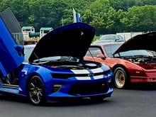 2016 SS Camaro w/lambo doors, supercharger and various ZL1 parts. Background the 87 GTA Trans Am which looked like a toy car beside the much larger 6th Gen