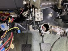 You can see the clutch MC rod in the center of the picture.  It's easy to notice that it is not perpendicular to the mounting pin sticking out of the side of the clutch pedal.  Pushing on the clutch pedal puts a lot of side force on that small locking clip.