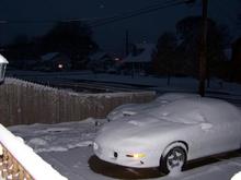 2002 camaro and 1978 anniversary corvette under snow.