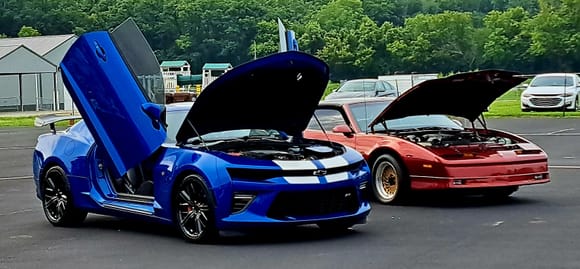 2016 SS Camaro w/lambo doors, supercharger and various ZL1 parts. Background the 87 GTA Trans Am which looked like a toy car beside the much larger 6th Gen