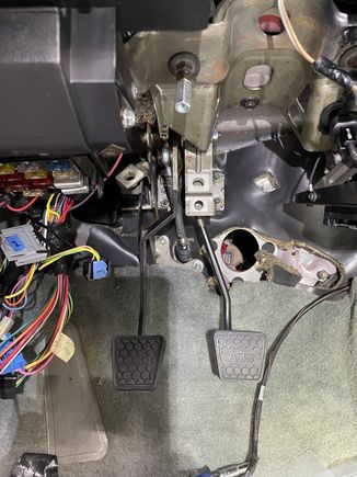 You can see the clutch MC rod in the center of the picture.  It's easy to notice that it is not perpendicular to the mounting pin sticking out of the side of the clutch pedal.  Pushing on the clutch pedal puts a lot of side force on that small locking clip.