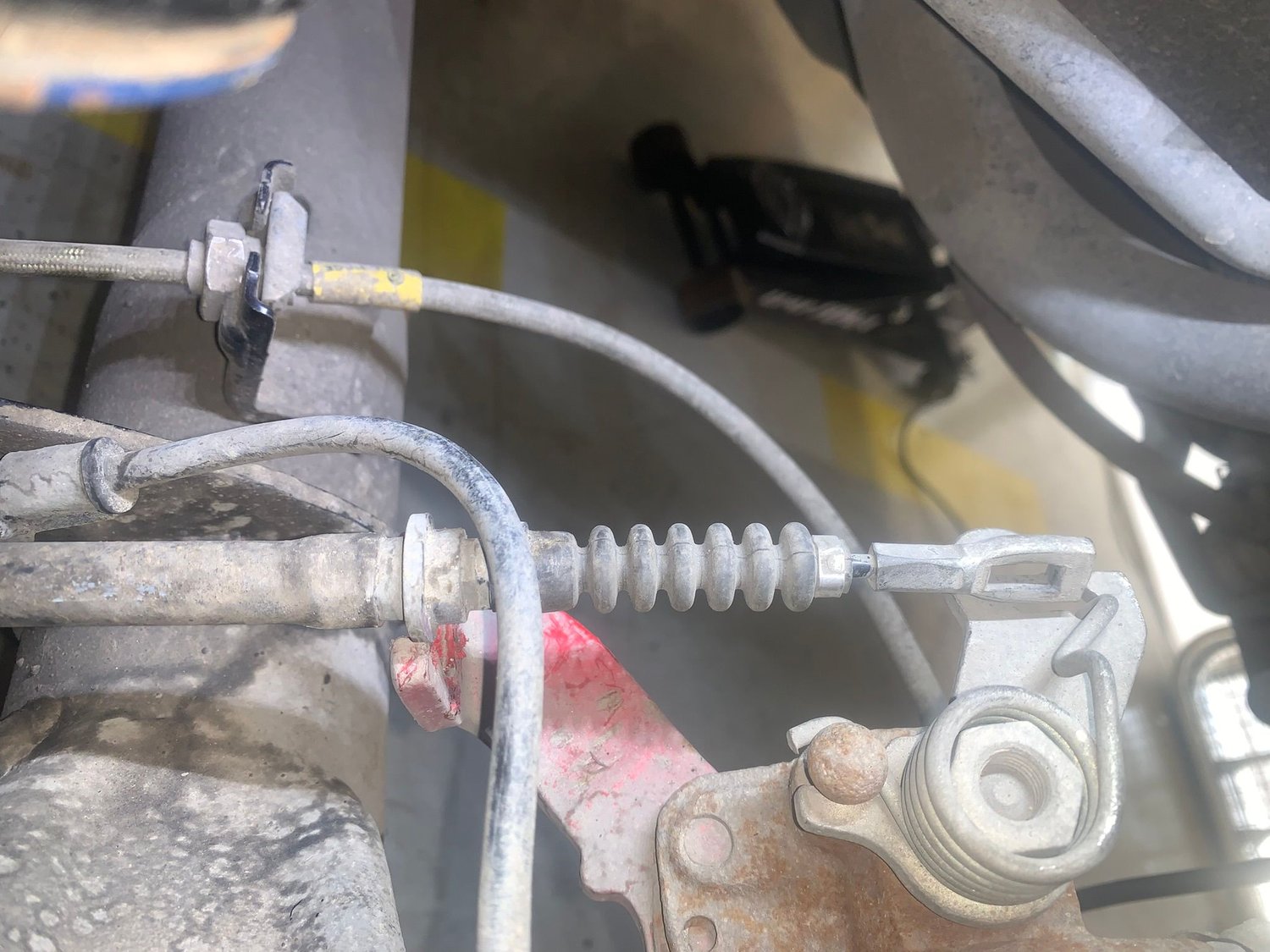 Drivers side unhooked from caliper lever and housing un-clipped from caliper 