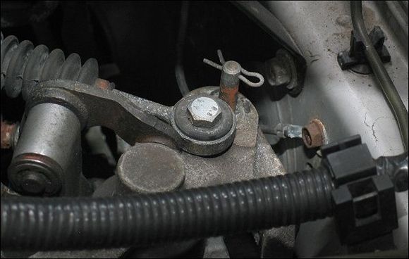 Short-throw-shifters are awesome, but so is the Free STS Modification. Just tap and drill a new hole on the shifter bracket, moving the cable about 3/4" closer to the transmission. Your shifter's vertical throw will be reduced by nearly half.

And not that you can tell by this photo, but that banjo bushing is solid polyurethane from Energy Suspension.