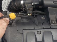 Straight back from the oil fill cap