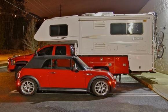 ref heavy in rear. The dodge 5500 has a custom made utility bed made for the camper. a open or enclosed trailer would just add more weight to the problem. a dolly would work but is there not someway to tow an automatic 4 down