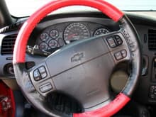 Wheelskins leather steering wheel cover.  Red leather is perforated.