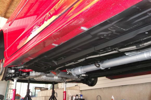 Front jack stands positioned under aluminum cradle.