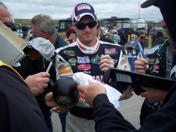 Dale Jr Signing the Dash out of the car.