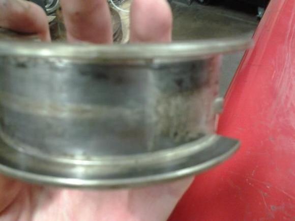 The engine was previously rebuilt, guessing in '79 from date on the back of the rod bearings.  Here you can see the marks of shims on the std. thrust bearing.