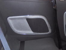 Shows rear inner panel with silver and chrome surround on rear radio speaker grill