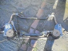 Found some cross member pics of manual racks Sierra 2wd’s it does look like a pinch fitting.