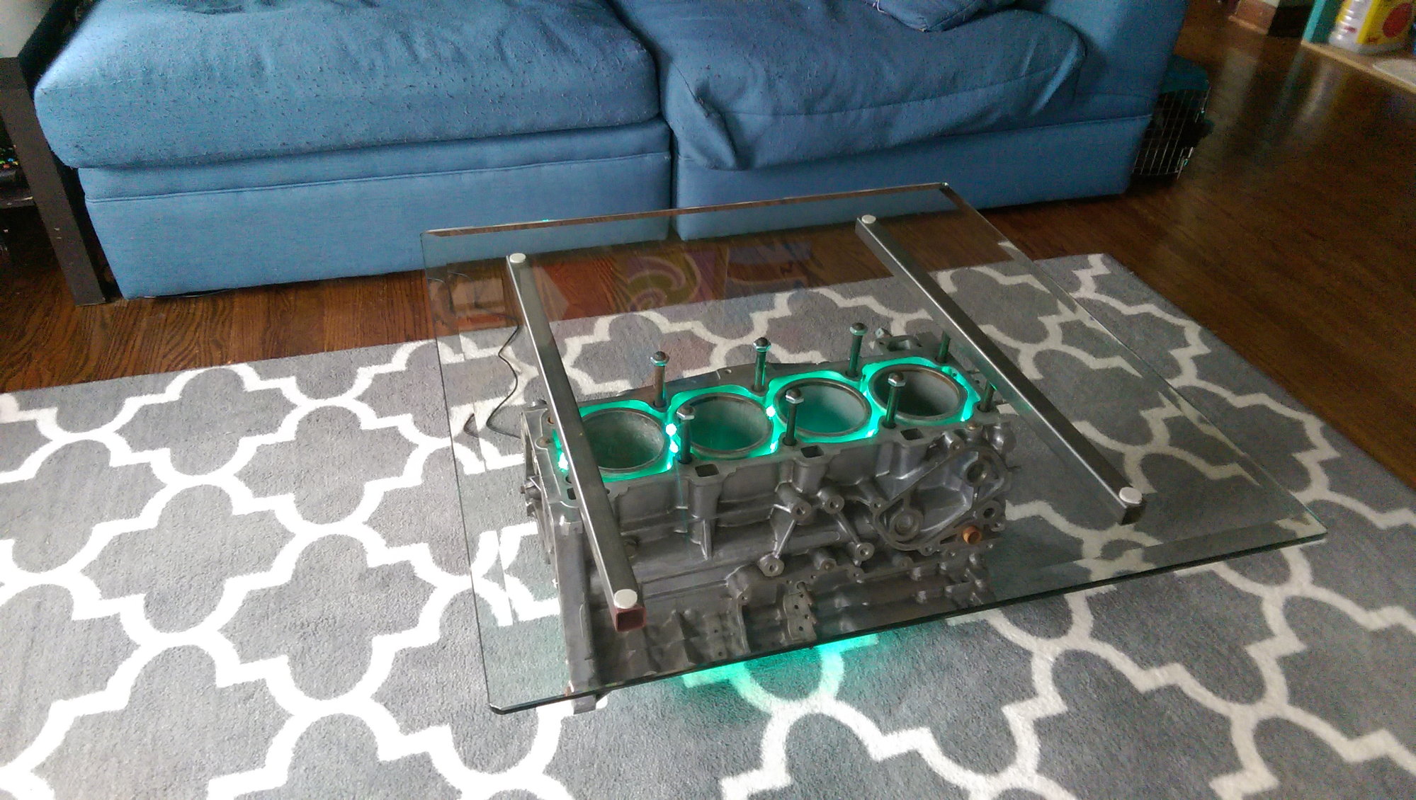 4 Cylinder Engine Coffee Table - 10 Coffee Tables Every Petrolhead Needs In Their House - A glass top is then fitted courtesy of four metal mounts and a set of six short slash cut header pipes are bolted into place.