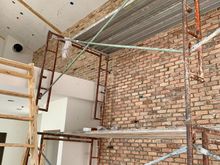 Exposed brick wall getting grout 