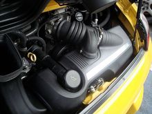 See two intake pipes merging together prior to the throttle body