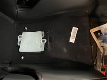 Passenger seat bottom without insert - the white item is the airbag sensor (do not disturb) and the white clips to either side that were un-clipped with the flathead screw driver