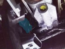 The switch locks into the metal bracket just in front of the highlighted switch. The bracket has key slots cut out at the top and the bottom so that the notches on the sides of the brake switch can go into these. Once slotted in then you twist to 45 degrees either way for it to lock