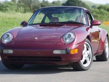 This 1996 Porsche 911 Carrera 4 coupe is shown in Arena Red over a cashmere leather interior and is powered by a 3.6 liter flat six paired with a six-speed manual transaxle and all-wheel drive.