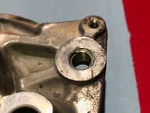 Heli-Coiled threads in brake caliper mounting bolt hole.