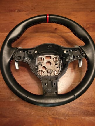 After removing trim, the paddle shifter hardware can be seen. Two 7mm nuts hold the paddle assemblies to the wheel.