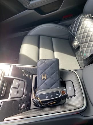 Love the matte carbon fiber.  No cup holder for me.  This is a girl's car so the handbag and keys need to match! 