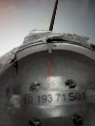 internal cutaway view of the atmosphere port that needs to be plugged/sealed in first step. Red shows to slot through to the outside, yellow shows the small hole to the channel where the Atmosphere port is located.