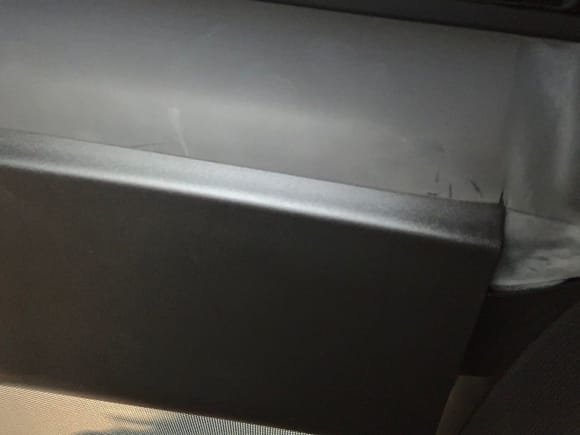 Rear edge of cover in its groove. This is looking from the back of the car facing forward.