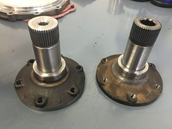 New Short Hub versus Old - note the shorter height and difference in the mounting bolt holes. The new setup requires a 40mm Allen head while the stock unit has a small center cylinder in the differential that fits into the old stub hub on the right.