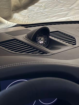 Center vents/speaker grille and Sport Chrono hood wrapped in leather with deviated stitching. 