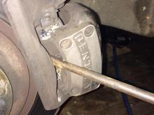 Leaver the piston back  to create slack / open the jaws .You can remove the cap of the brake fluid reservoir to assist the fluid moving ( not shown ) 