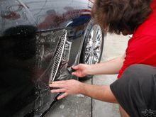 The guys from Clear Auto Bra are installing XPEL ULTIMATE on the front fenders