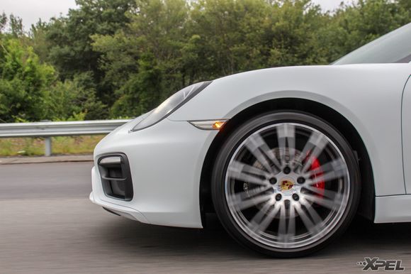 A sweet rolling shot of the white Cayman protected with XPEL STEALTH