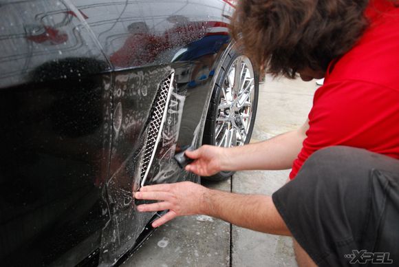 The guys from Clear Auto Bra are installing XPEL ULTIMATE on the front fenders