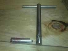 This is what the handle and locking pin look like.  The handle slides into the 2x6 and the pin slides down perpendicular to it and locks itself into the groove.