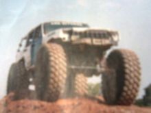 the snipit says   "with what appears to be the big Unimog portal axles, 52-inch michelin XL tires and an otherwise stockish, but obviously well used jeep on top of it, we were really curious about the buil. it's not easy to get those heavey drivetrain parts to stay under a unibody XJ. we never did catch up with the owner of this jeep:after walking through the obstical course like it was a small speed bump, the jeep and owner dissapeared"