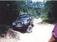 Cherokee in washout with willys following