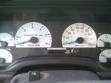 Florescent blue gauge needles on white gauges.