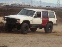 this is what it looks like now, the red door is on there cuz i had bought a new set of doors that had power windows and locks, only reason why just one is on there is cuz somebody decided that they needed my bag in the back seat so they busted out my window.