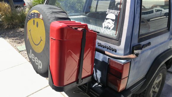 Gas can mounted to oem swing out carrier.