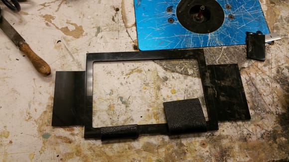 Abs frame routered to screen size. Extra length for wrapping around to cradle. Bought a dummy display model of the same tablet to destroy during build. Bottom right heated and wrapped around snug to tablet. Trimmed excess on bottom left.