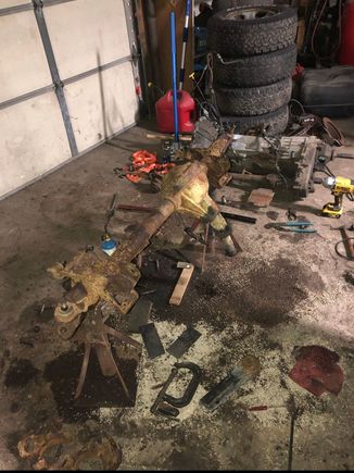 Disassembling the axle. Transmission and transfer case in the background. 