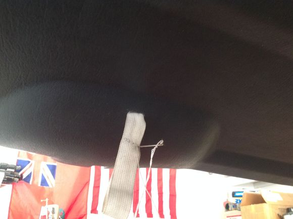 Sewing a loop in the end of the strap.  I used nylon to assure no rattles