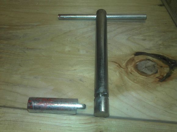 This is what the handle and locking pin look like.  The handle slides into the 2x6 and the pin slides down perpendicular to it and locks itself into the groove.