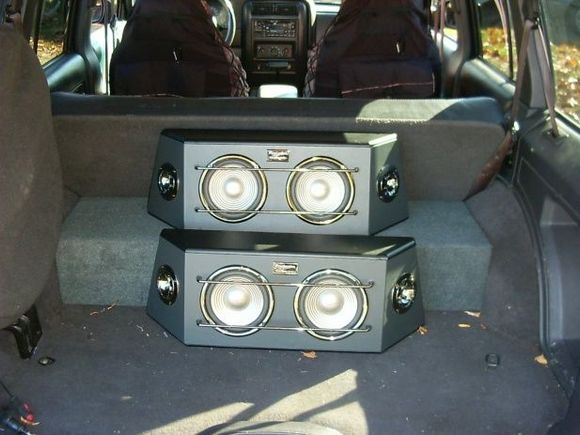 i know its a sound system, but its not loaded with bass. it is just so that i can play it loud when doing stuff while out of the jeep. it is all removeable and i used velcro to  hold them down. 
Edit: took bottom one out, its much better now :D