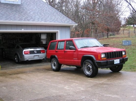 The Jeep has to sit outside and the Stang gets the garage.