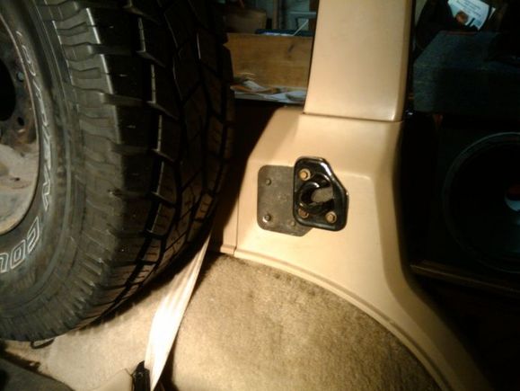 the tire rubbed on the top of the rear seat and tailgate so i made a bracket to move the seat back forward.