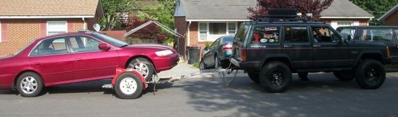 Jeep towing a broken down pos Honda,,,again