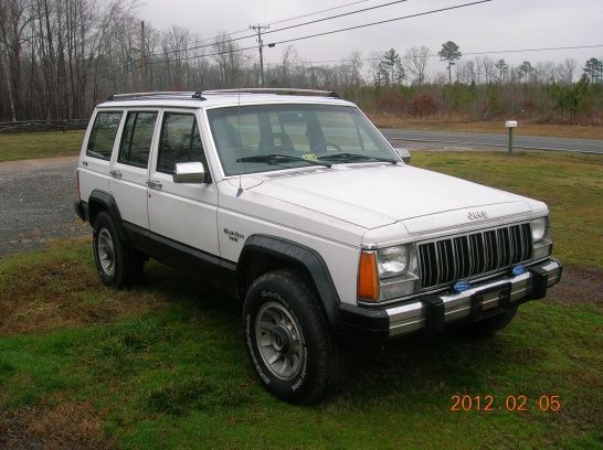 heres my 89 cherokee laredo, i looks better than it did when it was given to me, the fender flares and bumper corners were faded to grey the lower black was grey with body molding that looked crappy. i took that off and painted it black, i also painted fender flares and bumper corners with  black plastic paint. i also added the foglights.