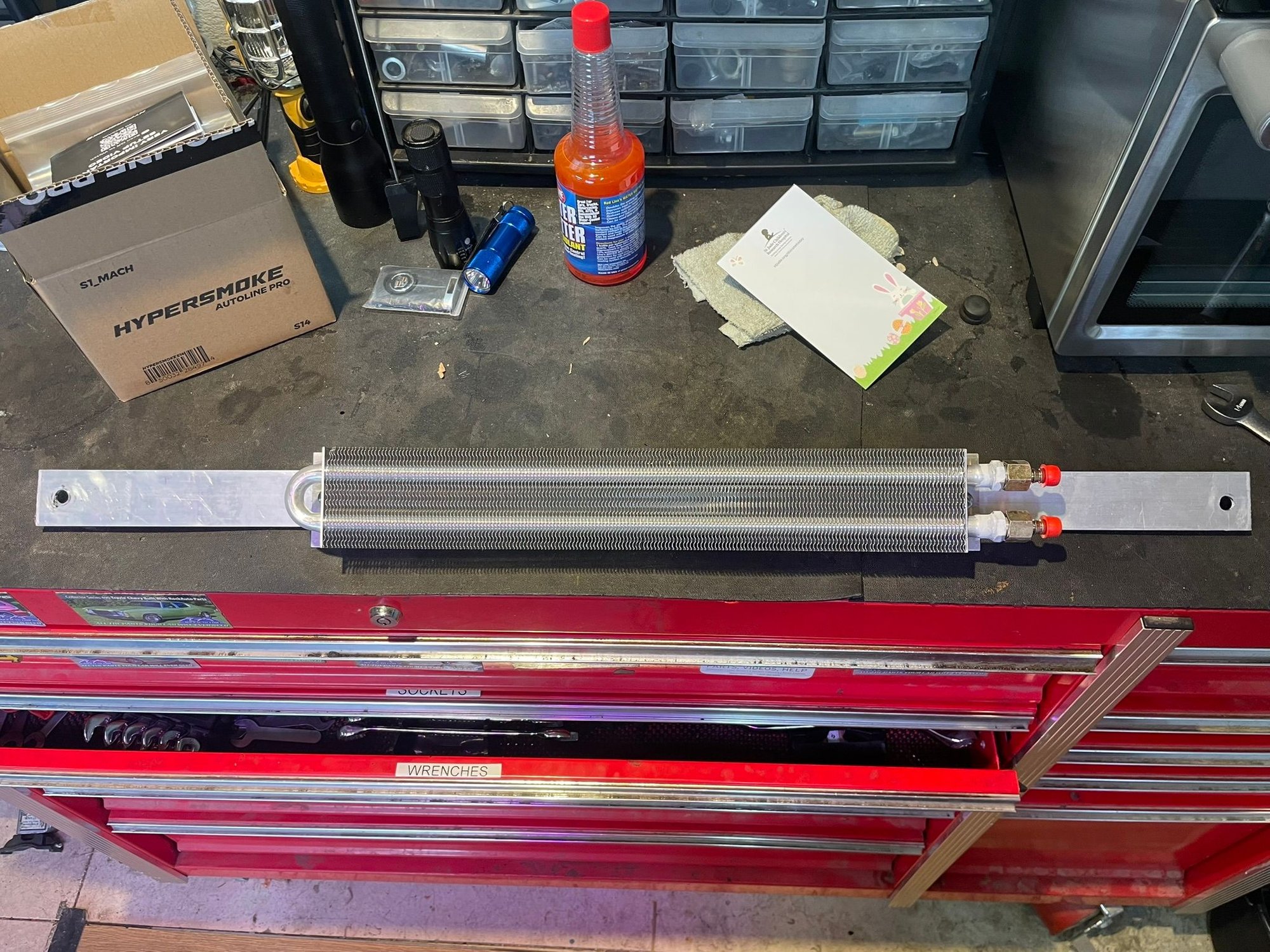 The cooler mounted on the aluminum flat bar. The holes have to be elongated slightly because the bolts on the bumper are not parallel.