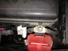 There are 2 wires under the red plastic cover, one to the battery and the other goes down to the starter. 
There’s a wire that connects to the power steering, you can see it just to the left . 